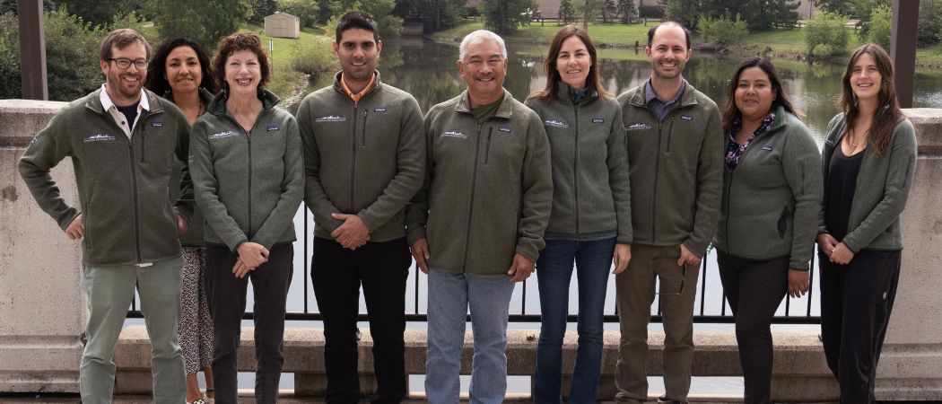 American Farmland Trust staff stand together in front of a little pond.